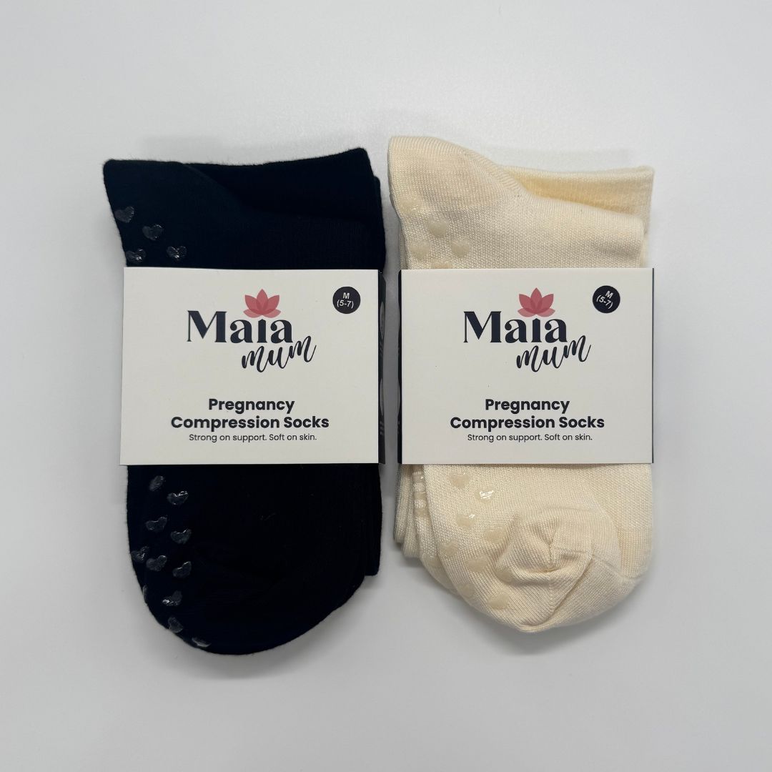 Two pairs of pregnancy compression socks, one navy and one cream, with Maia Mum labels on a light gray background.